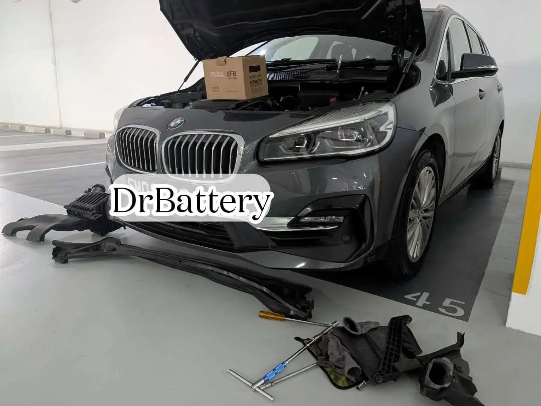 DrBattery onsite service with a BMW bonnet open and battery tools beside the car