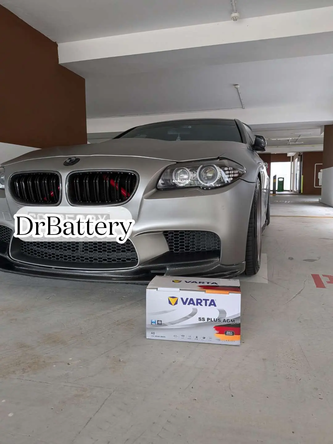 BMW parked with a VARTA replacement battery in front of the vehicle